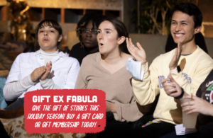 In red text box: Gift Ex Fabula. Give the gift of stories this holiday season! Buy a gift card or gift membership today! Background image of people clapping